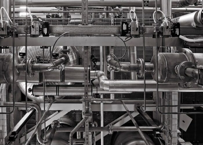 Complex industrial piping and machinery in a modern plant