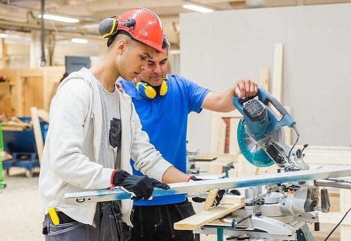 Apprentices receive hands-on woodworking training in a workshop