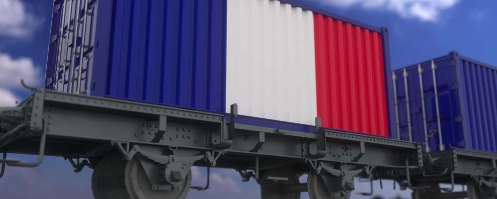 Freight train carrying blue, white, and red shipping containers