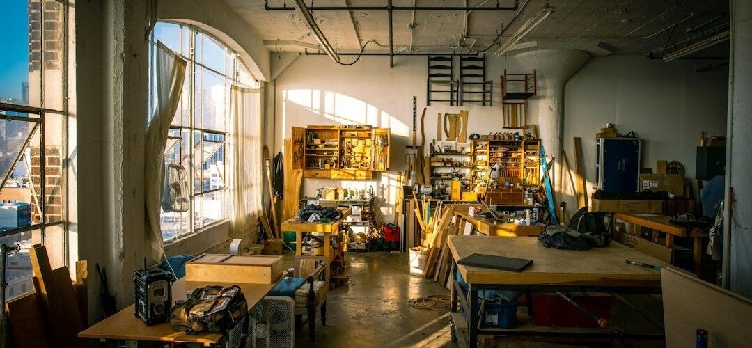 Sunlit workshop with organized tools, workbenches, and materials