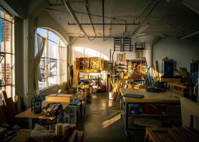 Sunlit workshop with organized tools, workbenches, and materials